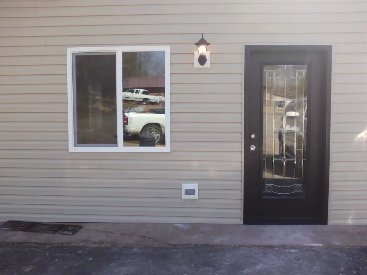 New siding, window and entry door on the side of an addition in Glenshaw