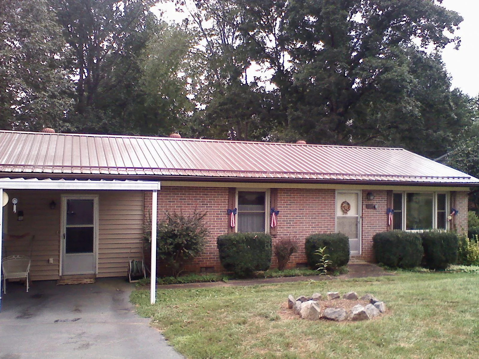 Bronze metal roof and carport on a brick ranch home — Roof Repair work by our crew in Glenshaw